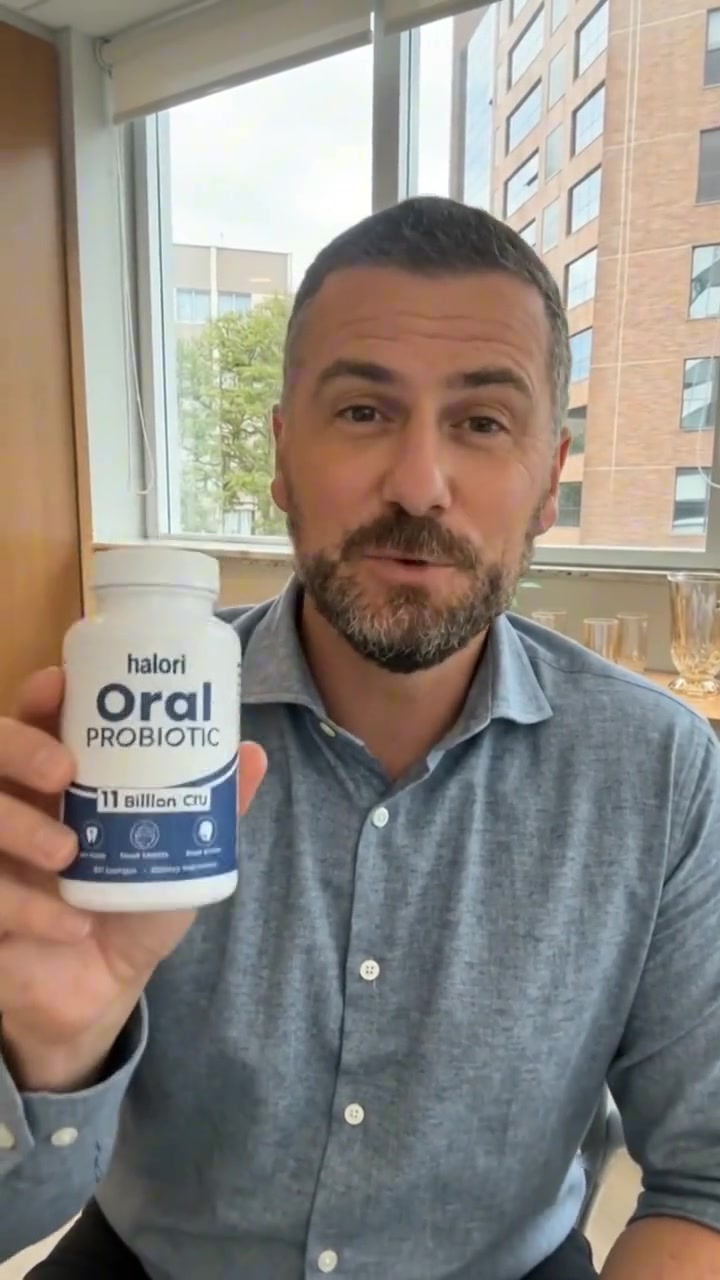 Halori customer holding the Oral Probiotic bottle
